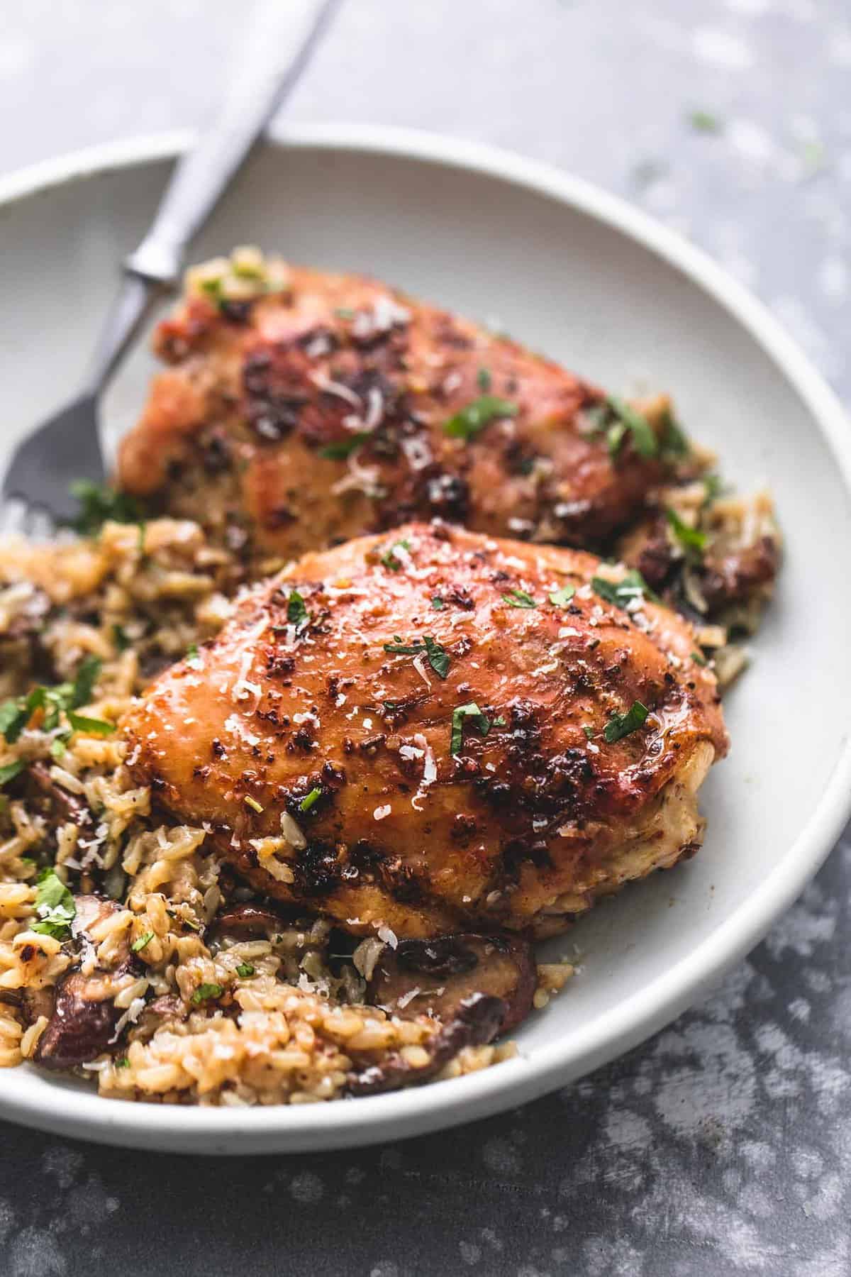 instant pot parmesan chicken and mushroom rice and a fork on a plate.