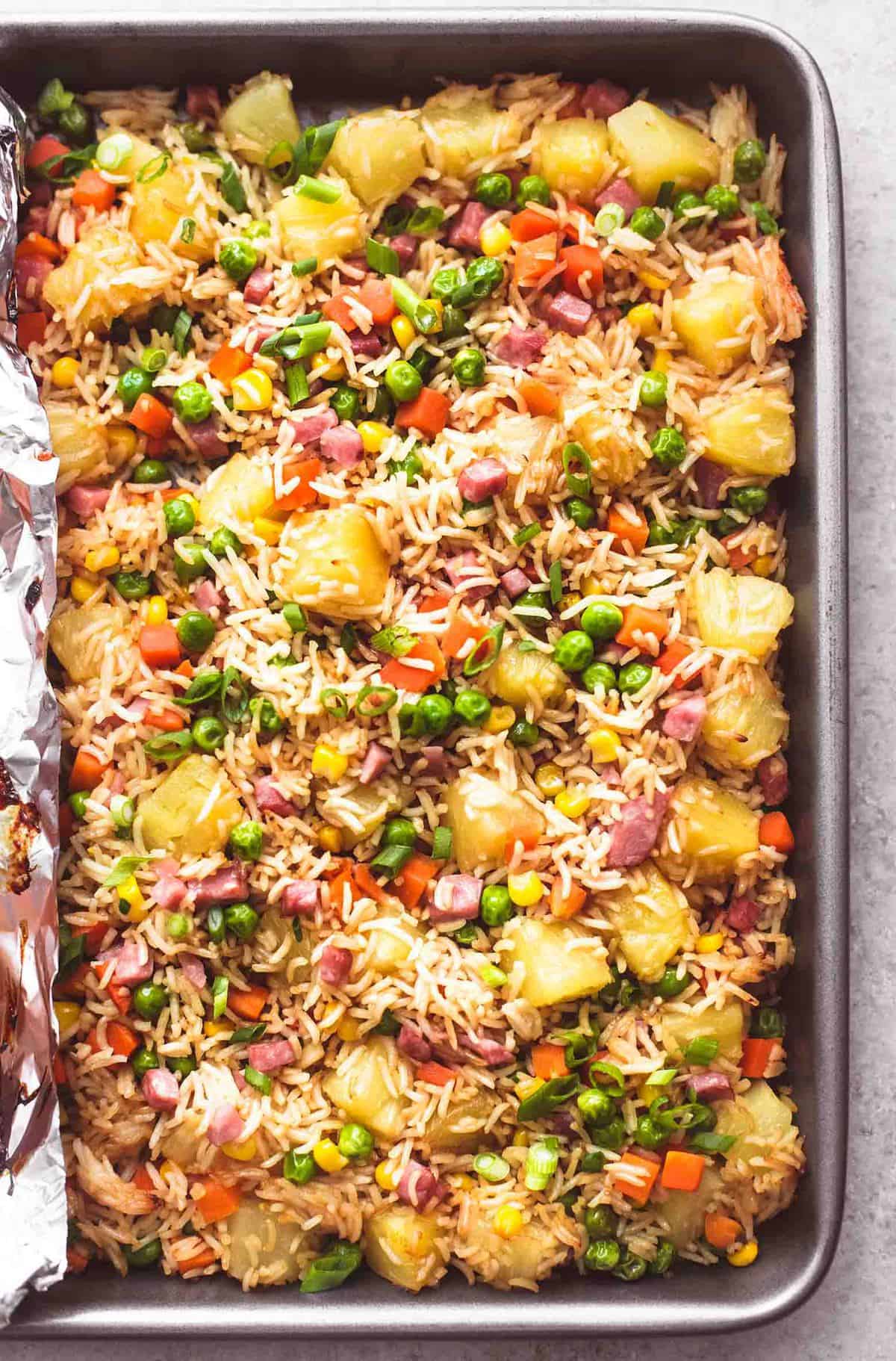 close up top view of pineapple rice on a sheet pan.