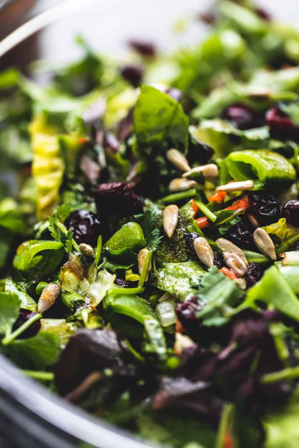 close up of chopped Asian salad in a glass bowl.