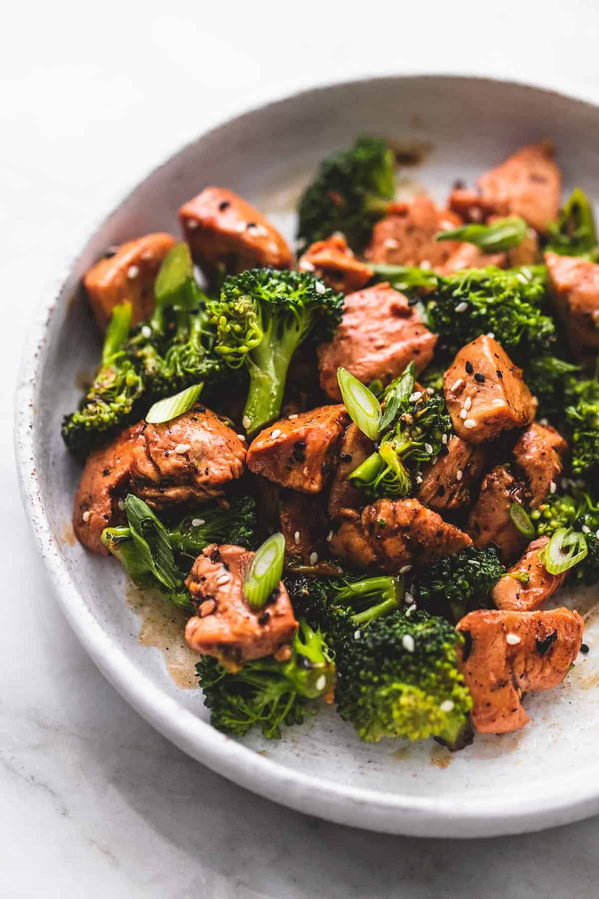 close up of chicken and broccoli stir fry on a plate.