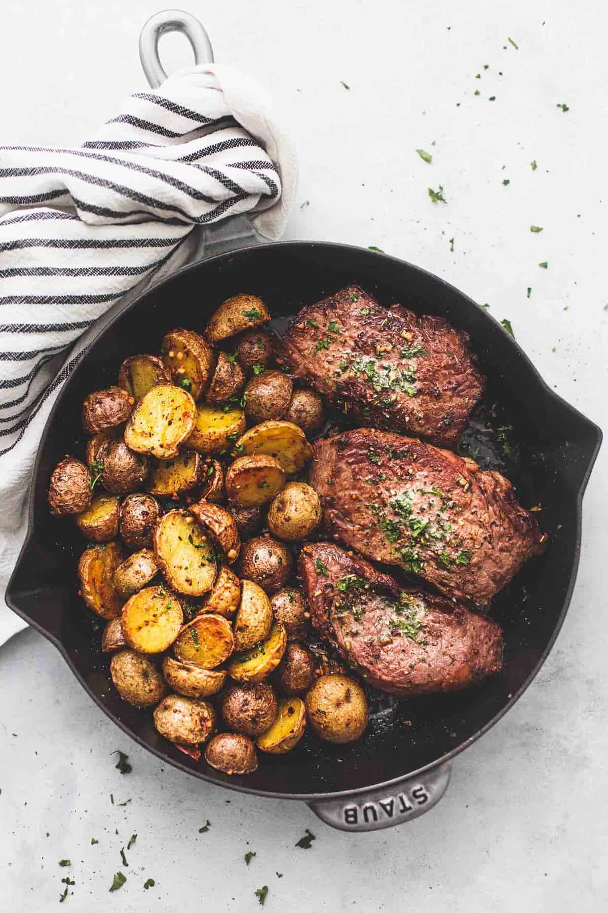 top view of garlic butter steak and potatoes skillet in a skillet.