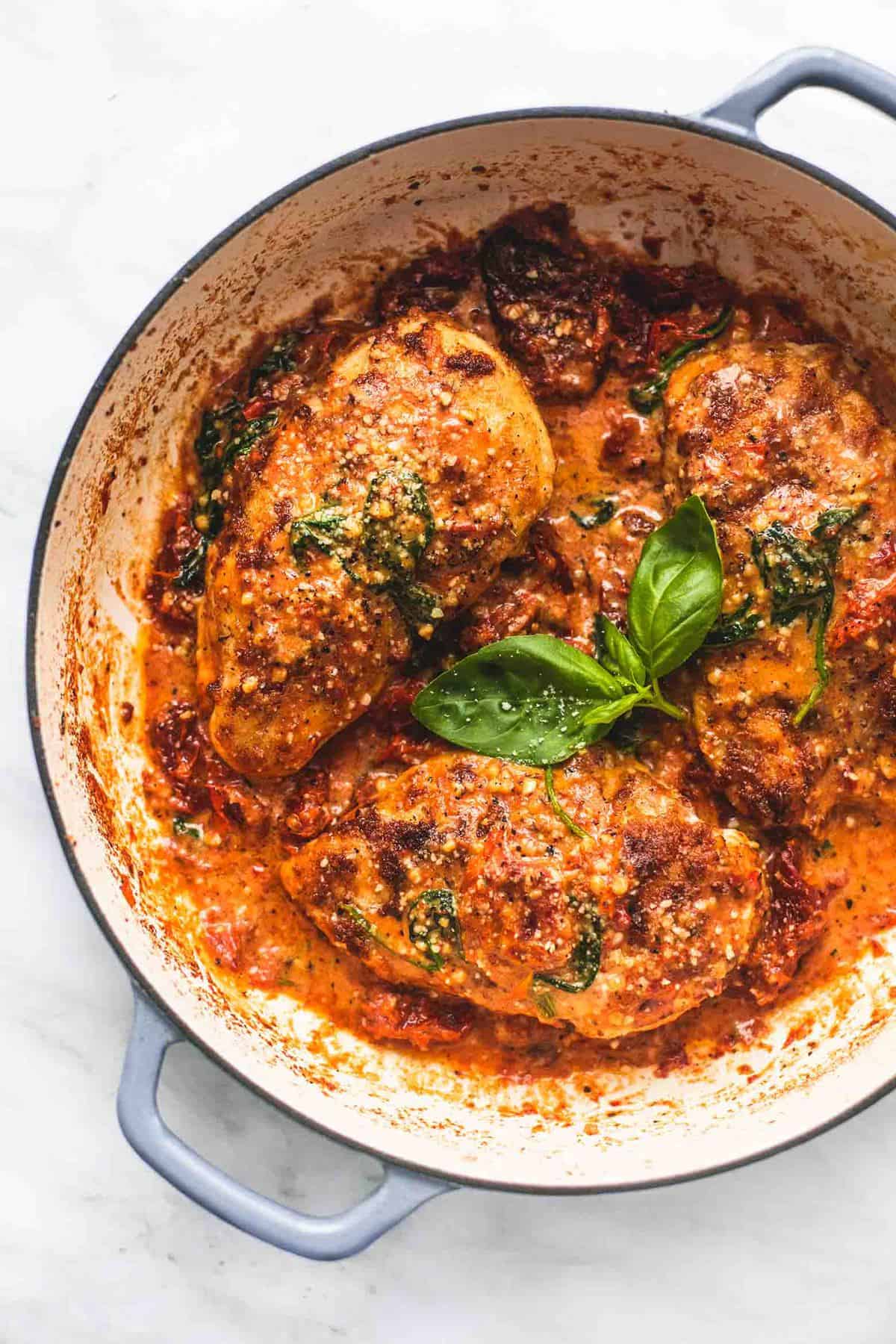 top view of creamy Tuscan parmesan chicken in a pan.