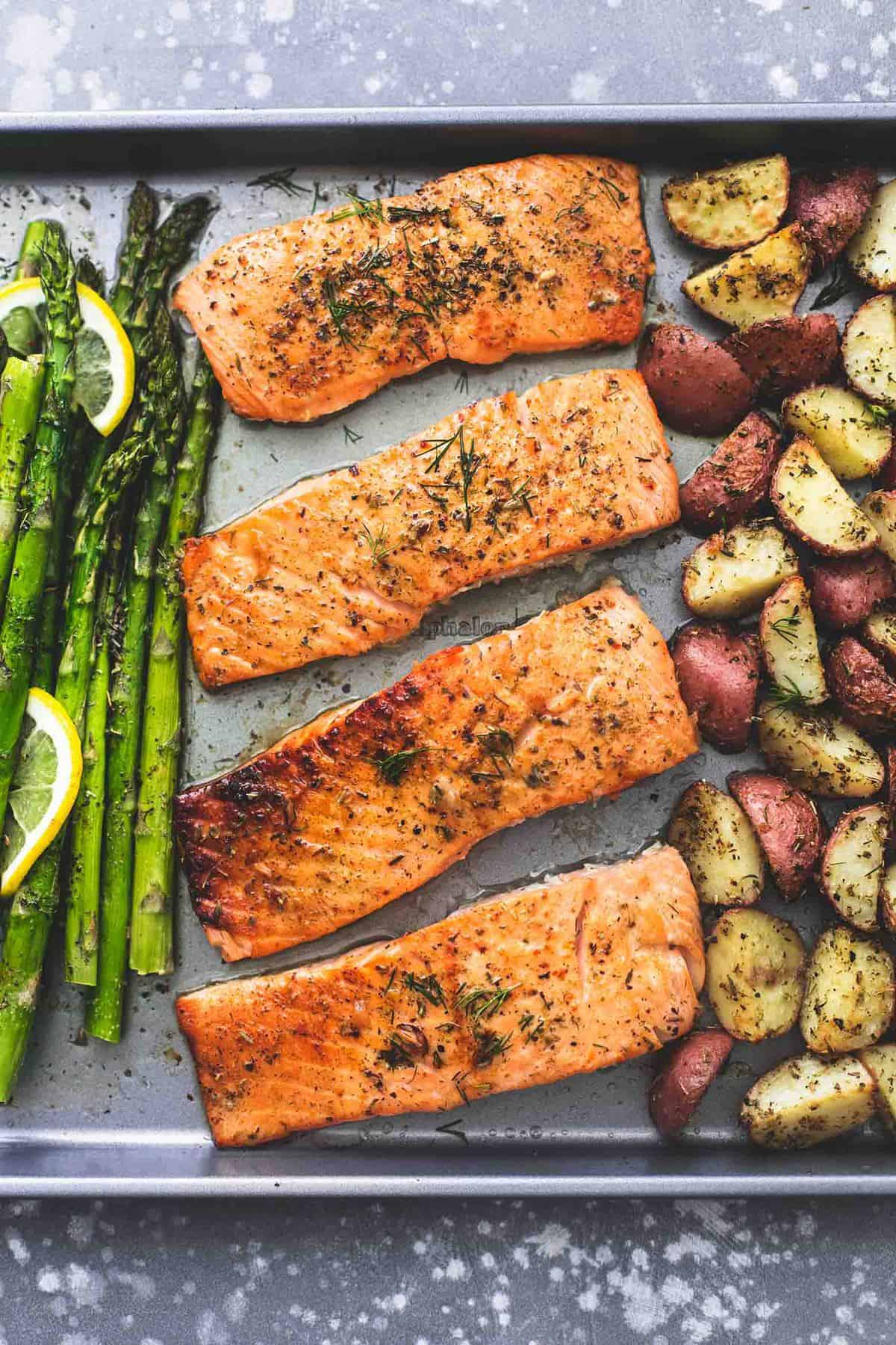 top view of sheet pan baked salmon and asparagus with potatoes on a sheet pan.