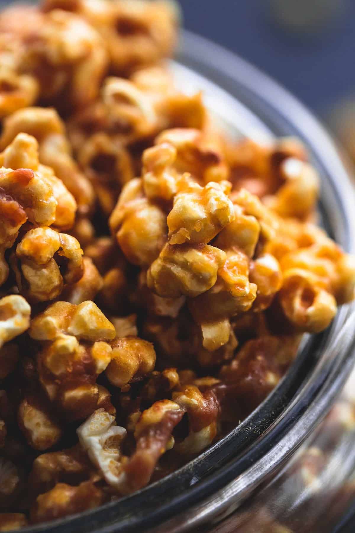 close up of caramel corn in a tall glass jar.