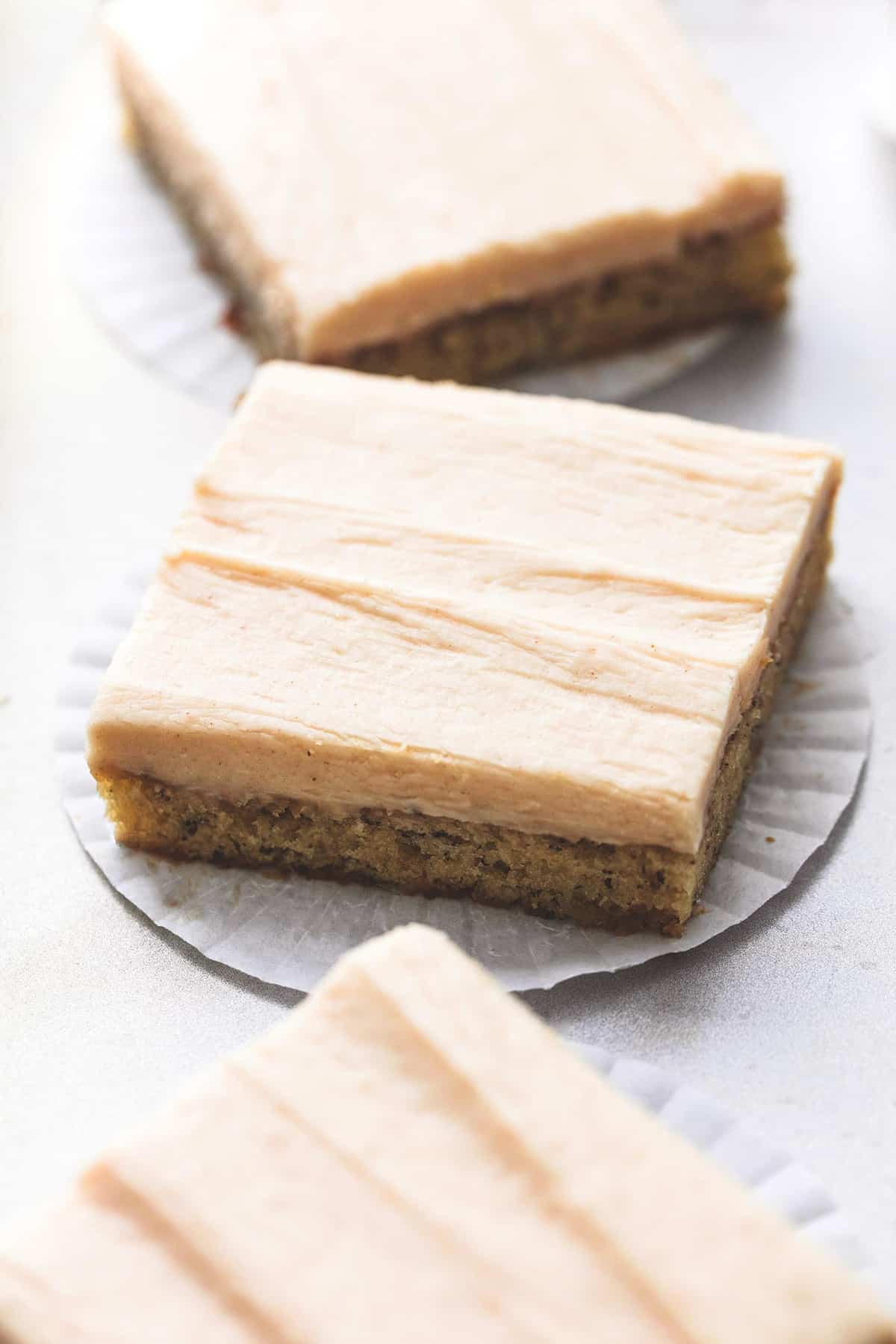 a banana bar with cream cheese frosting with a bar above and below it.