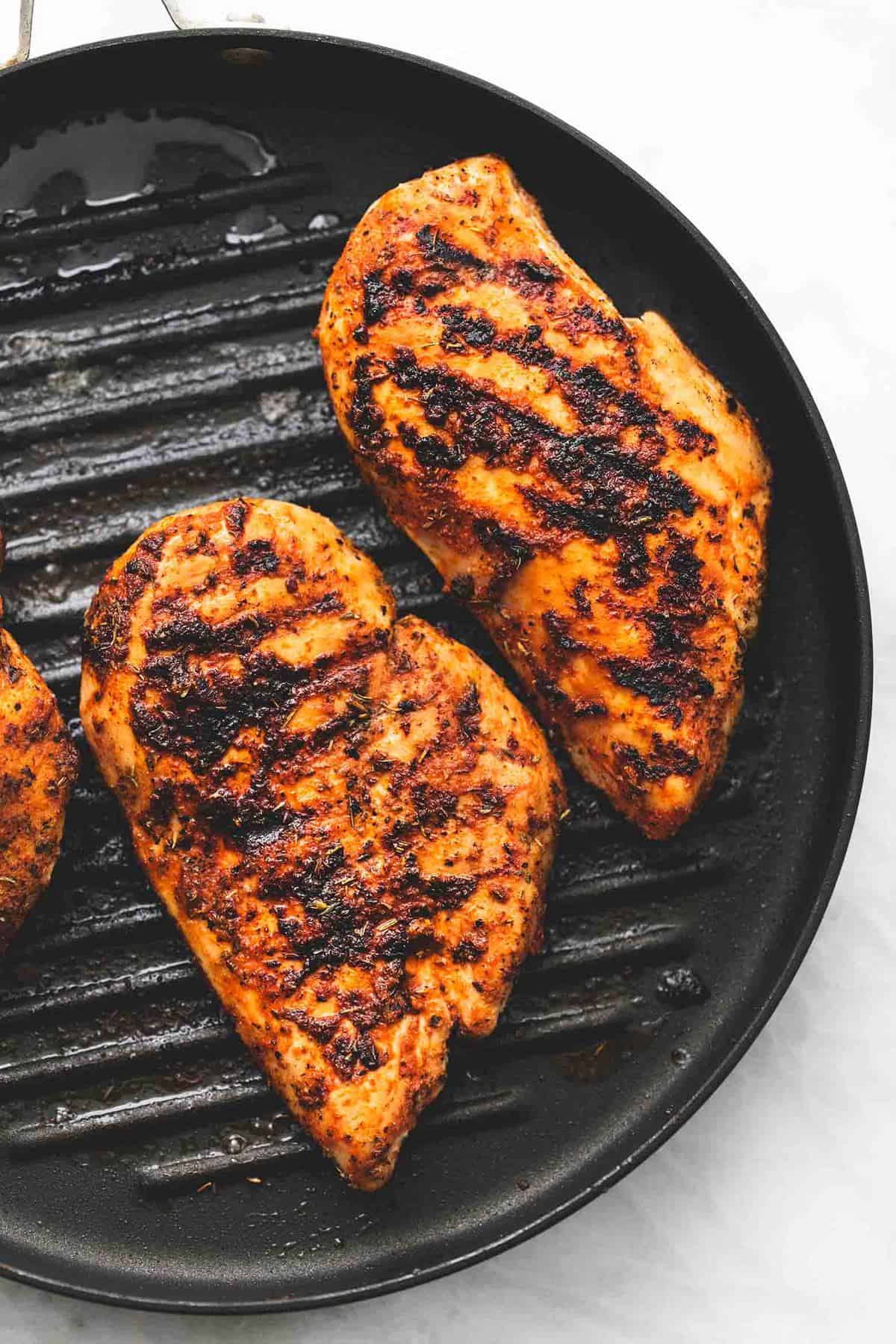 top view of chicken on a grill.