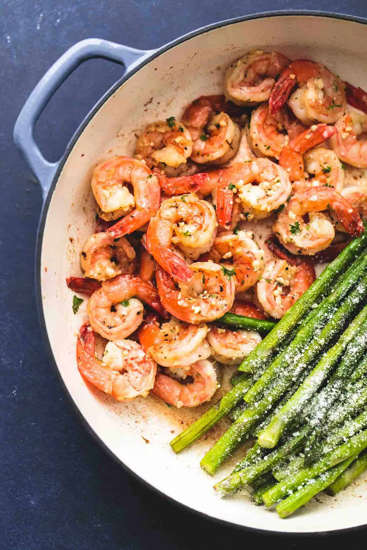close up top view of one pan shrimp and asparagus in a pan.