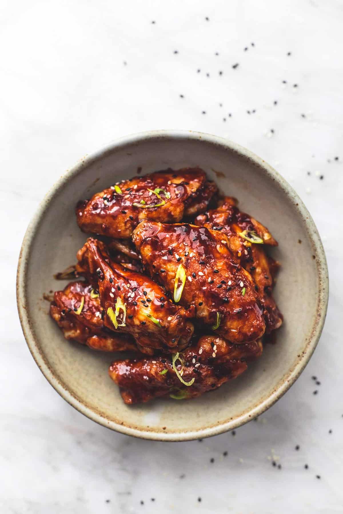 top view of spicy Korean bbq chicken wings on a plate.