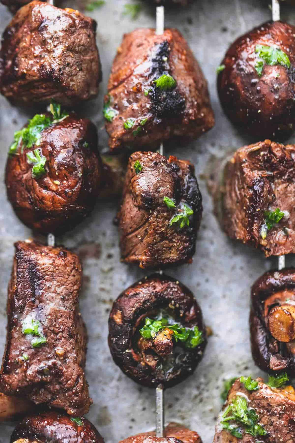 close up top view of grilled steak and mushroom kabobs.