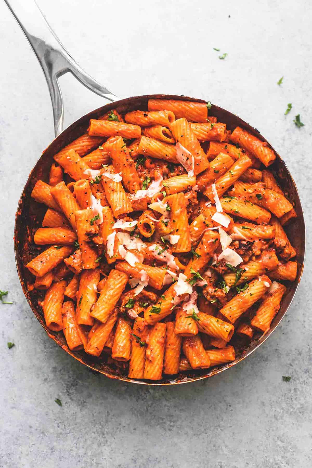 top view of creamy red pepper pasta in a pan.