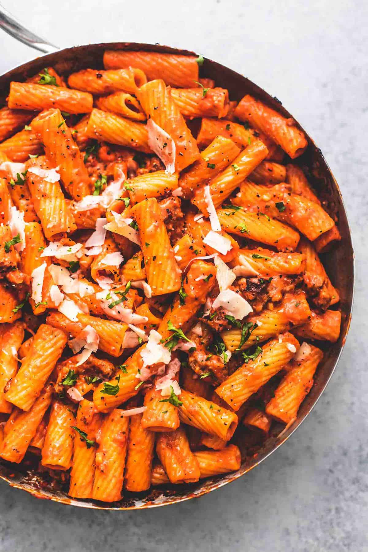 top view of creamy red pepper pasta in a pan.