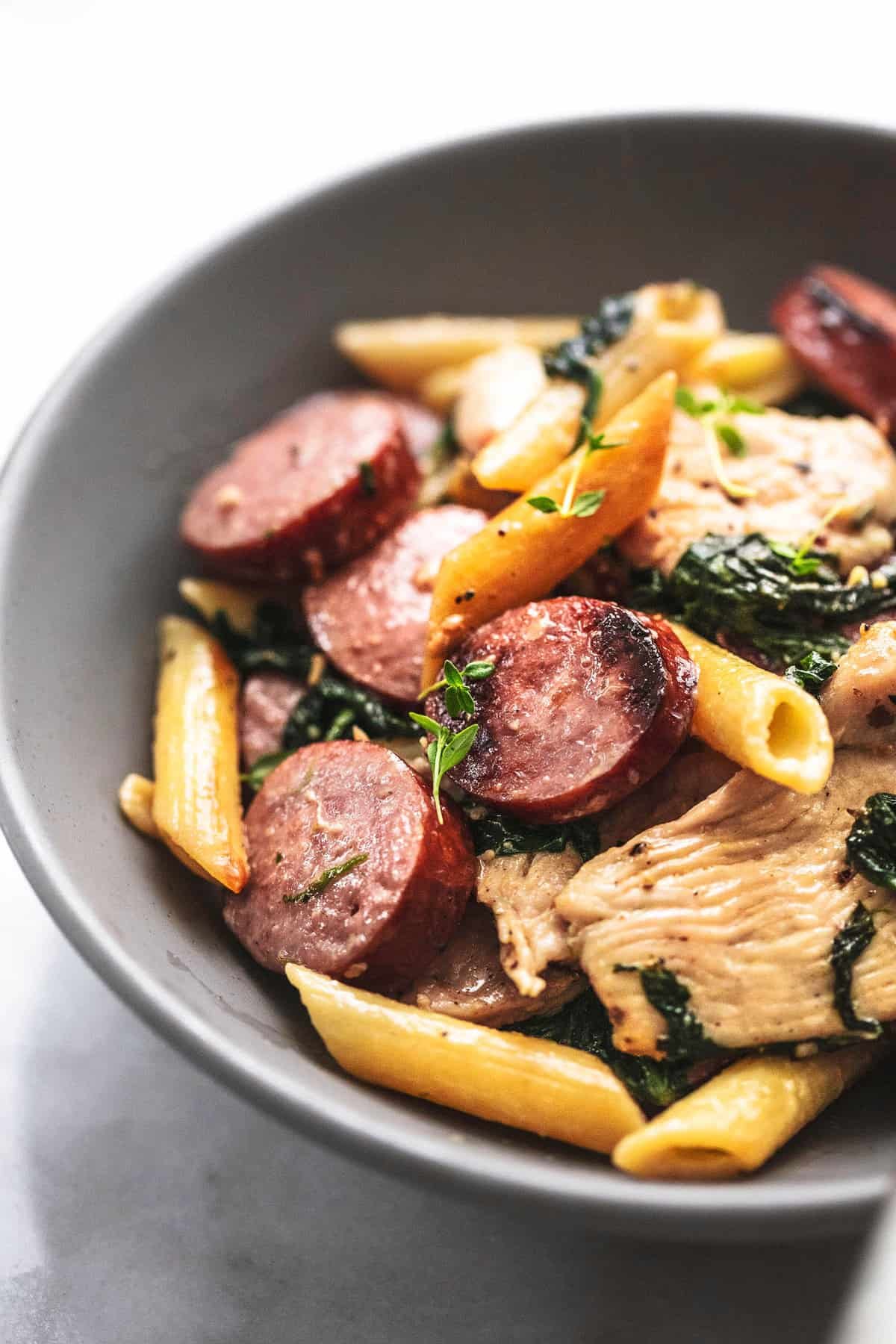 close up of chicken and sausage pasta in a bowl.