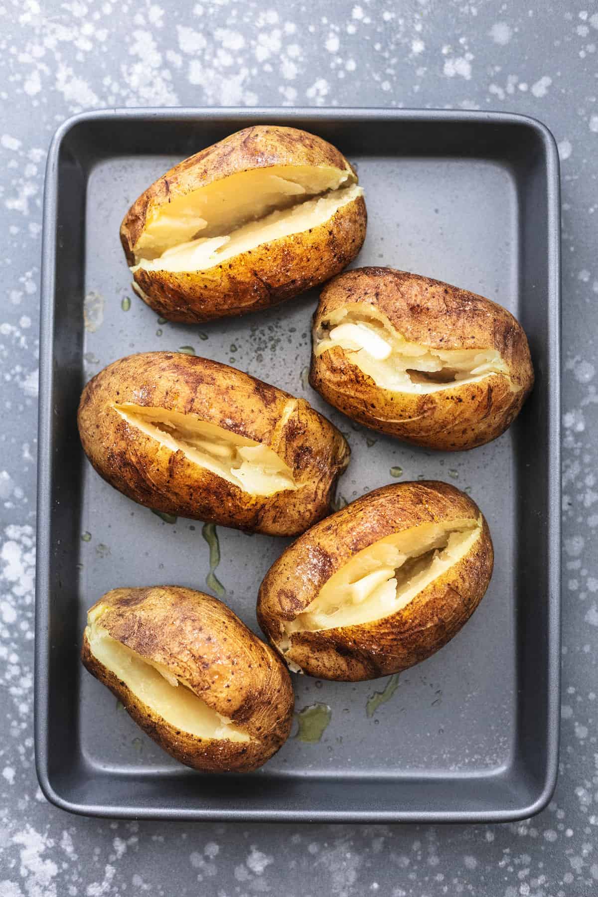 top view of instant pot baked potatoes on a baking sheet.