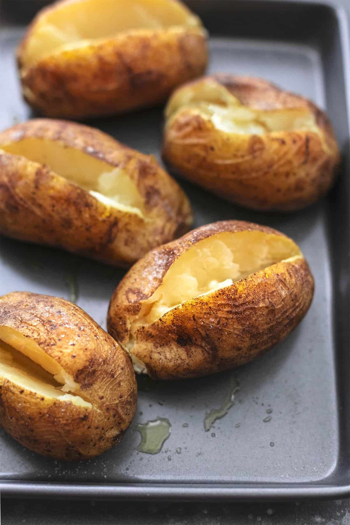 close up of instant pot baked potatoes on a baking sheet.