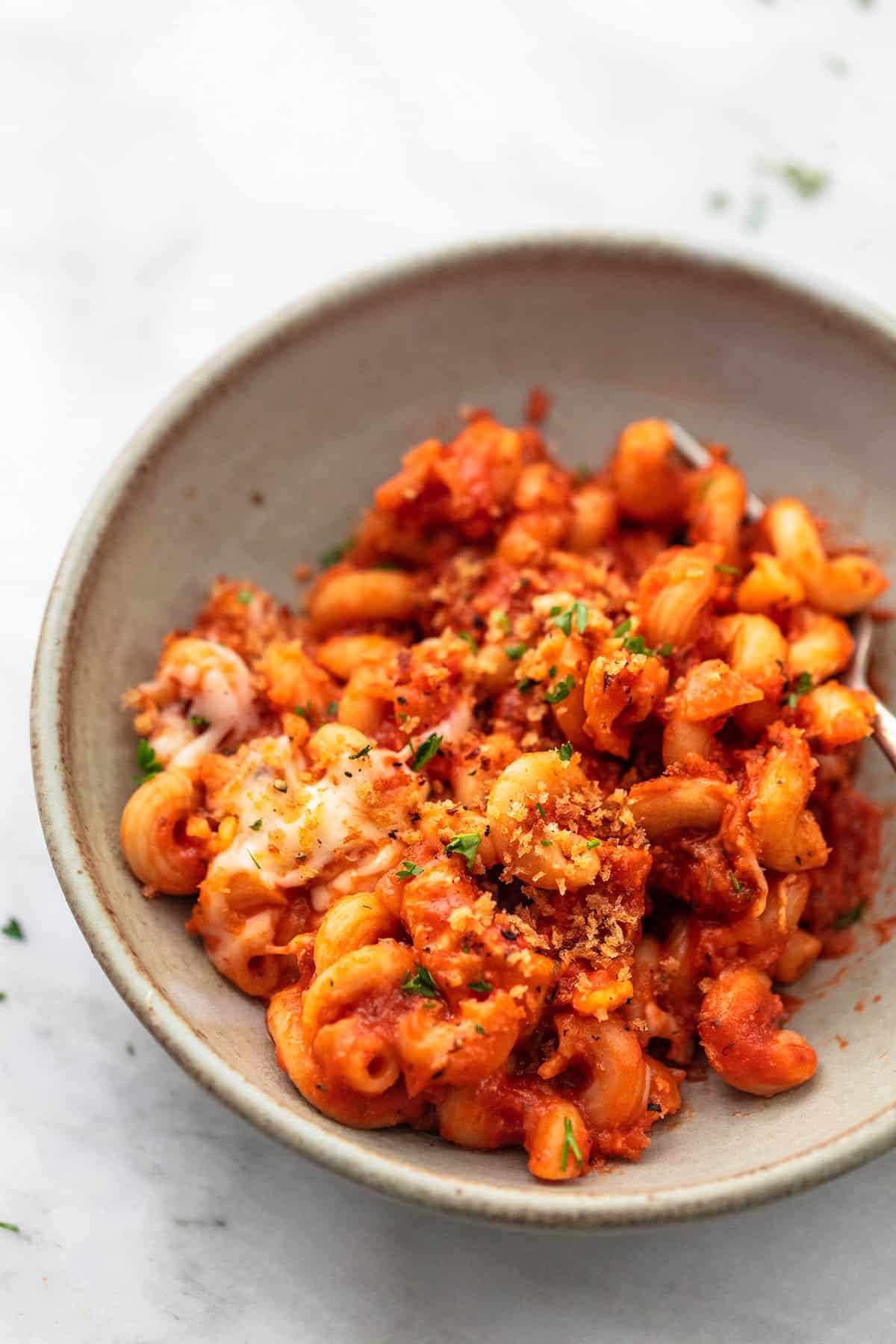 chicken parmesan pasta with a fork in a bowl.