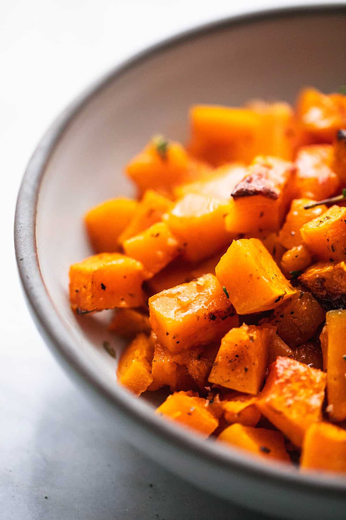 close up of roasted butternut squash in a bowl.