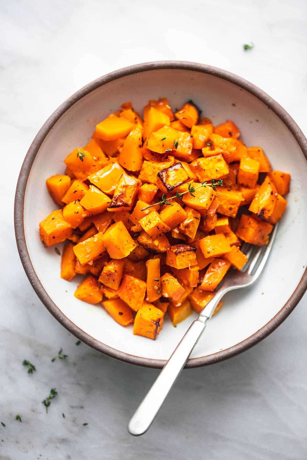 roasted butternut squash with a fork in a bowl.