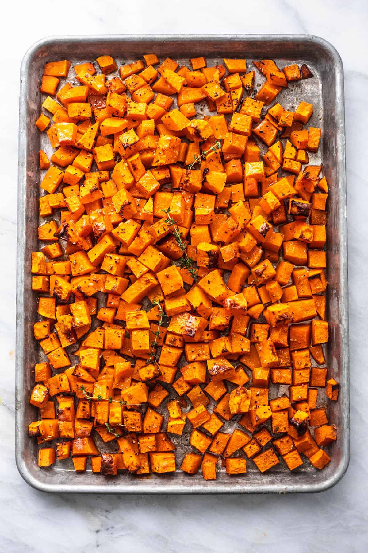 top view of roasted butternut squash on a baking sheet.