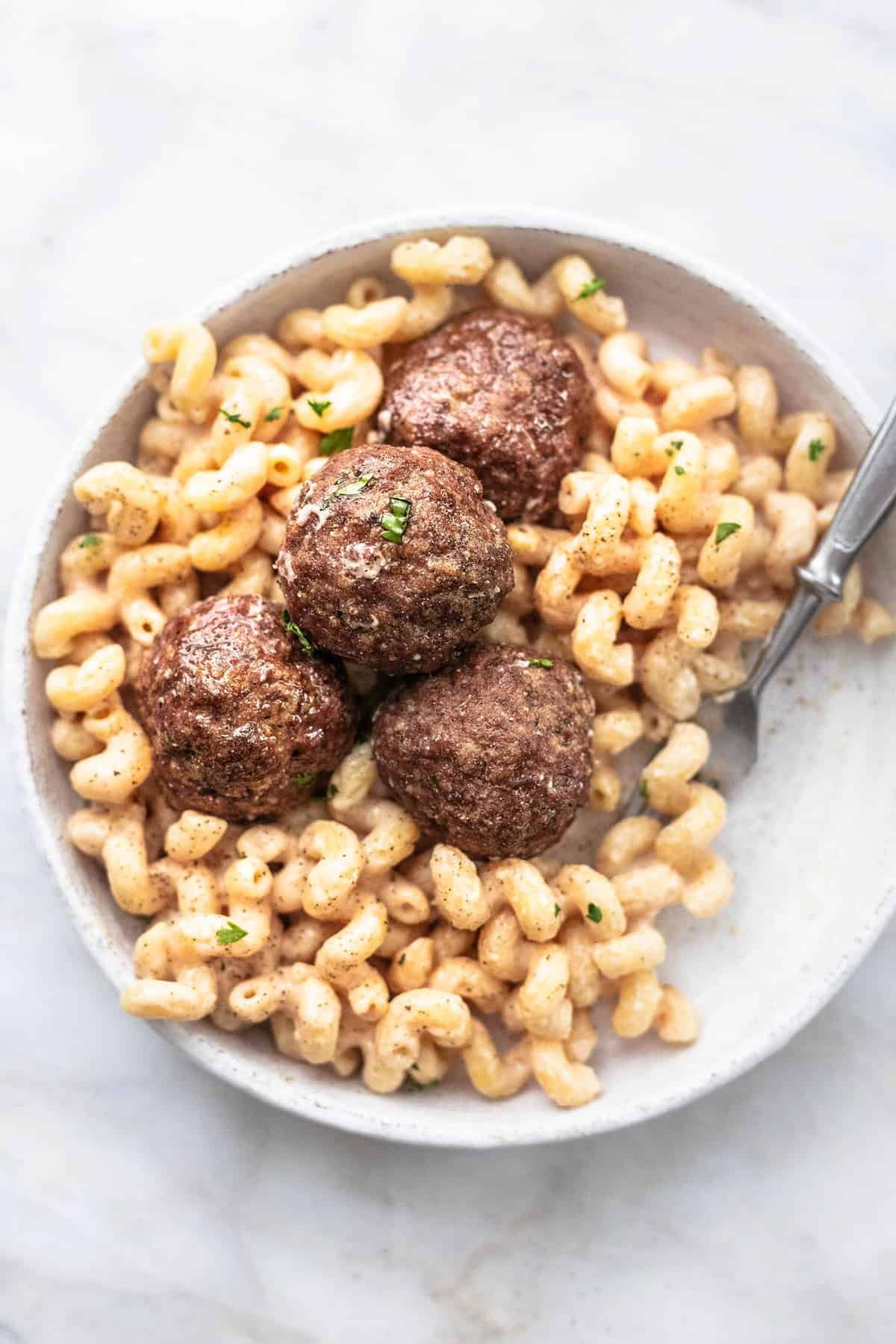 top view of Swedish meatball pasta with a fork on a plate.