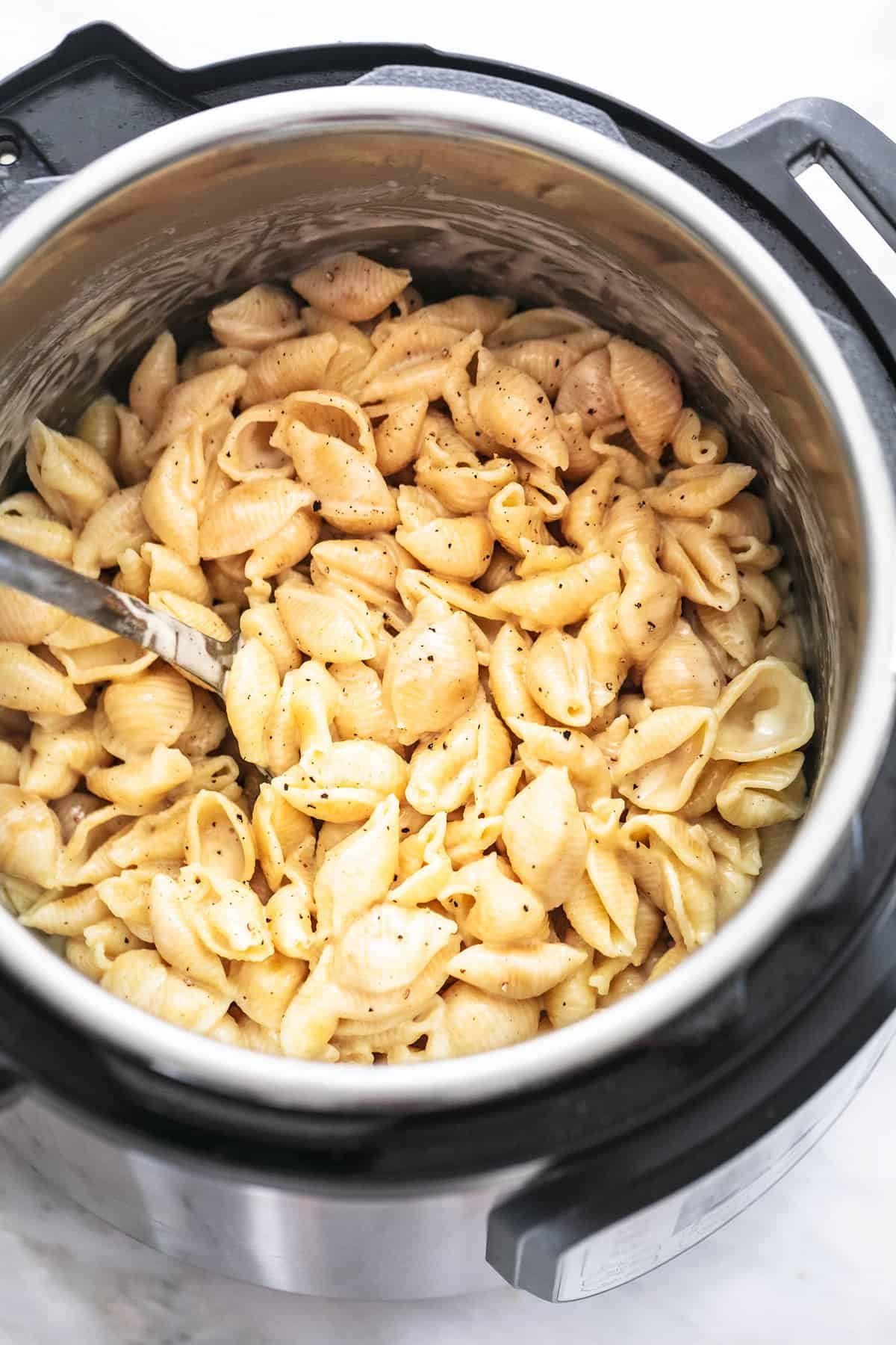 top view of instant pot mac and cheese with a serving spoon in an instant pot.