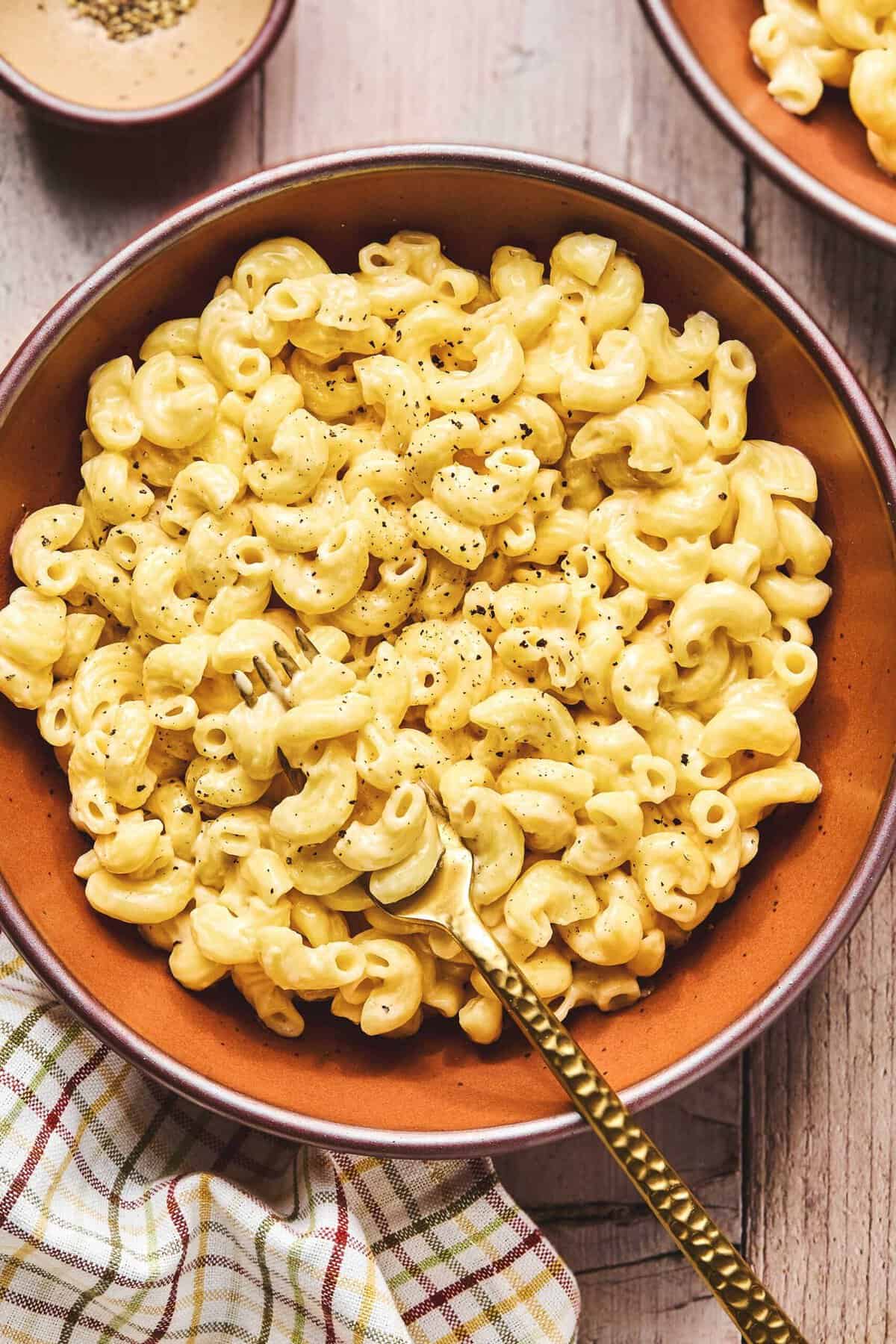 Overhead of instant pot mac and cheese with a fork in a bowl.
