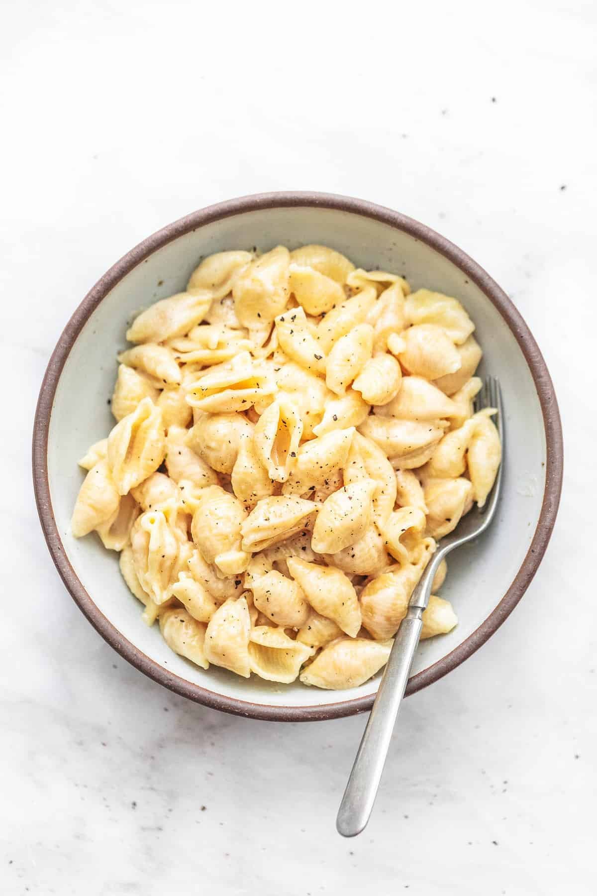 top view of instant pot mac and cheese with a fork in a bowl.