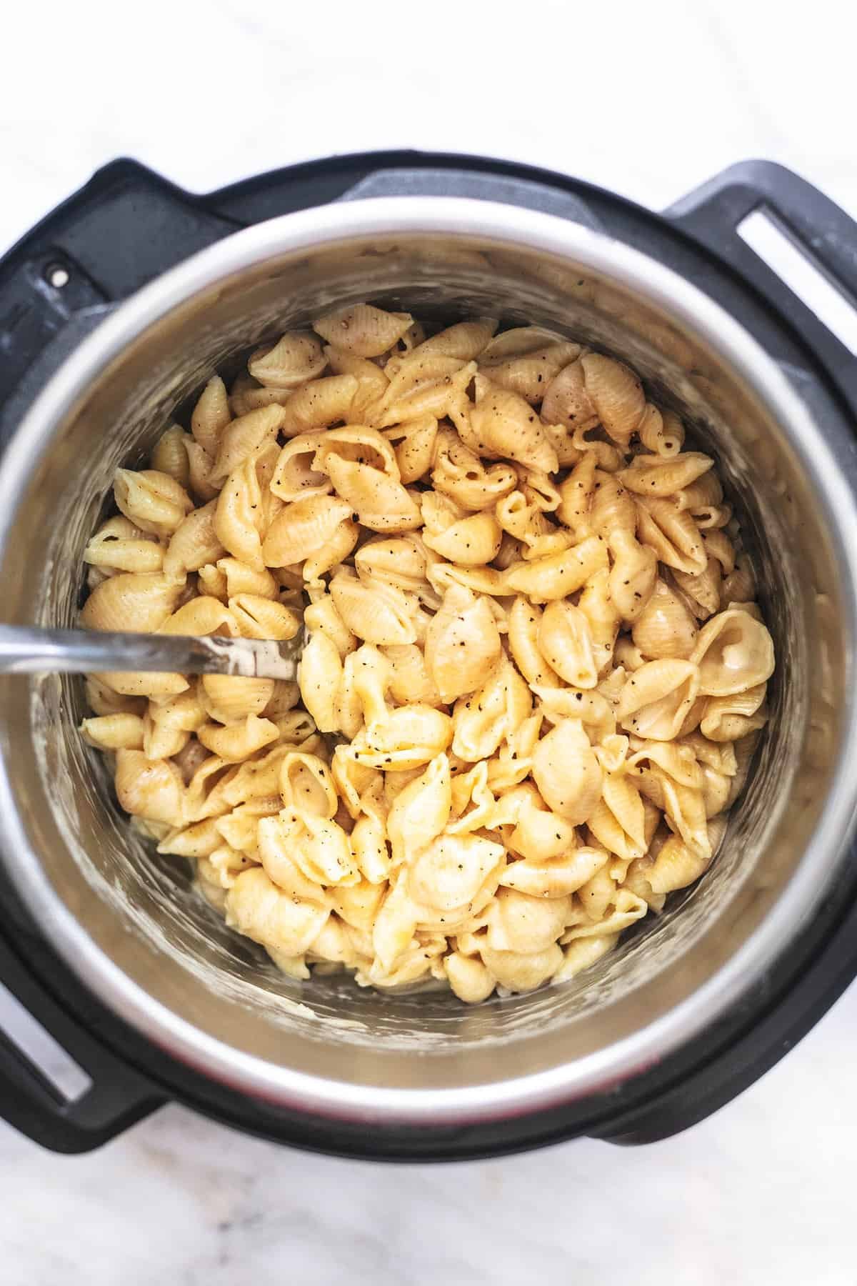 top view of instant pot mac and cheese with a serving spoon in an instant pot.