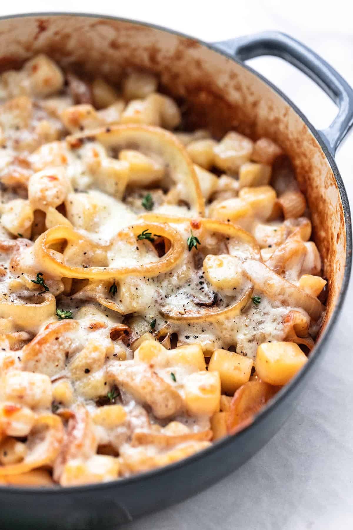 close up of French onion potatoes in a pan.