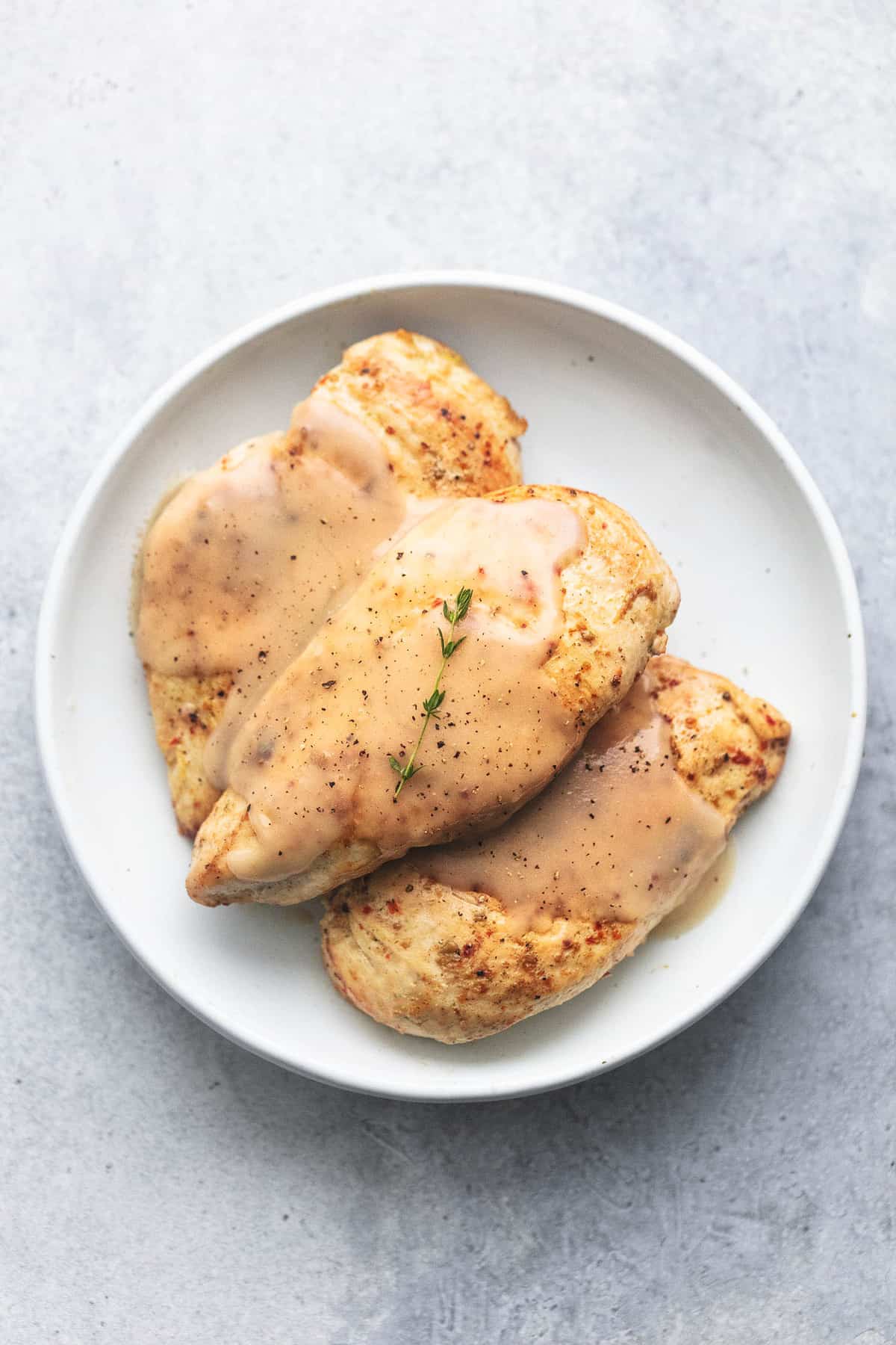 top view of instant pot chicken breast and gravy on a plate.