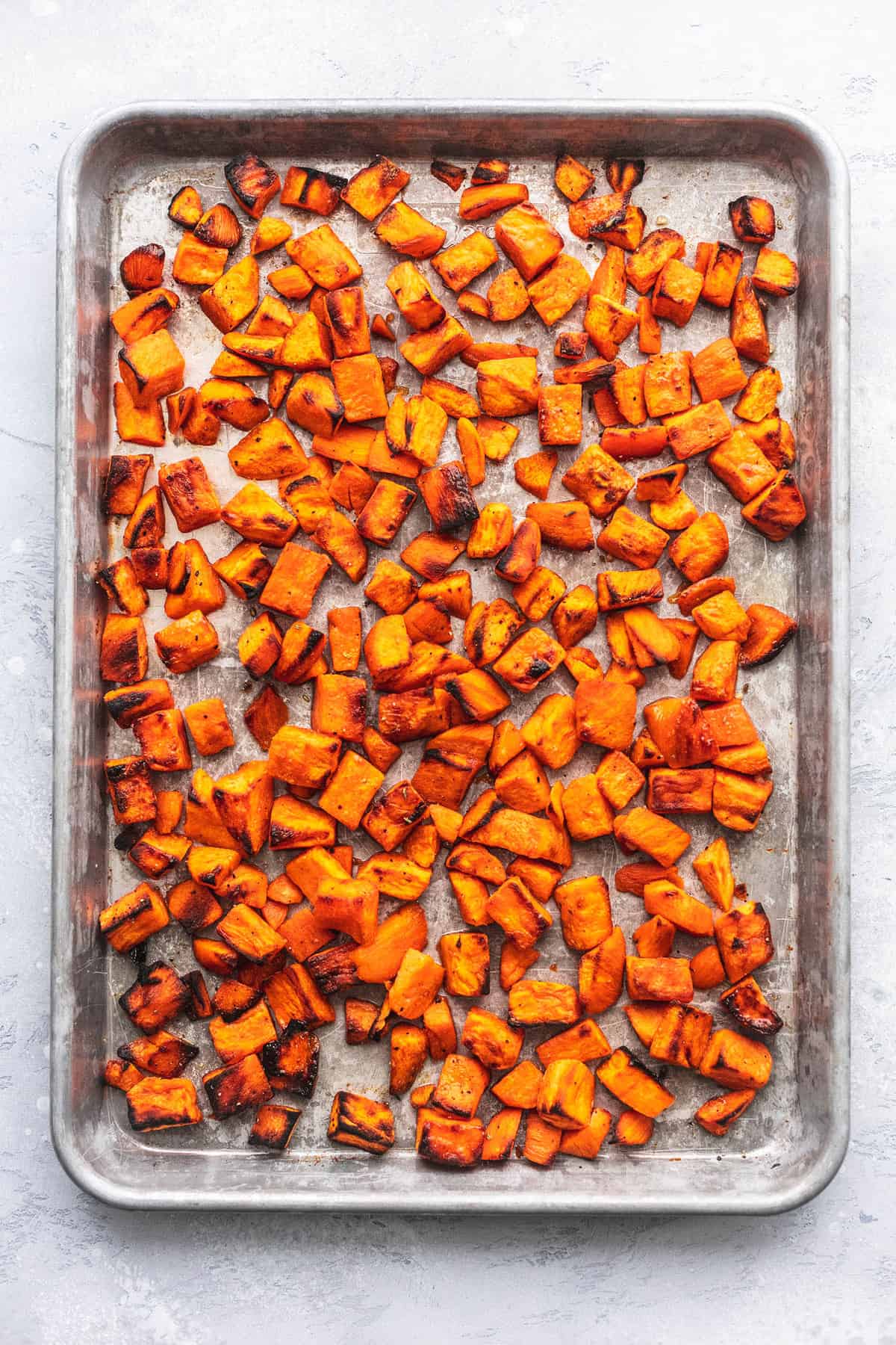top view of roasted sweet potatoes on a baking sheet.