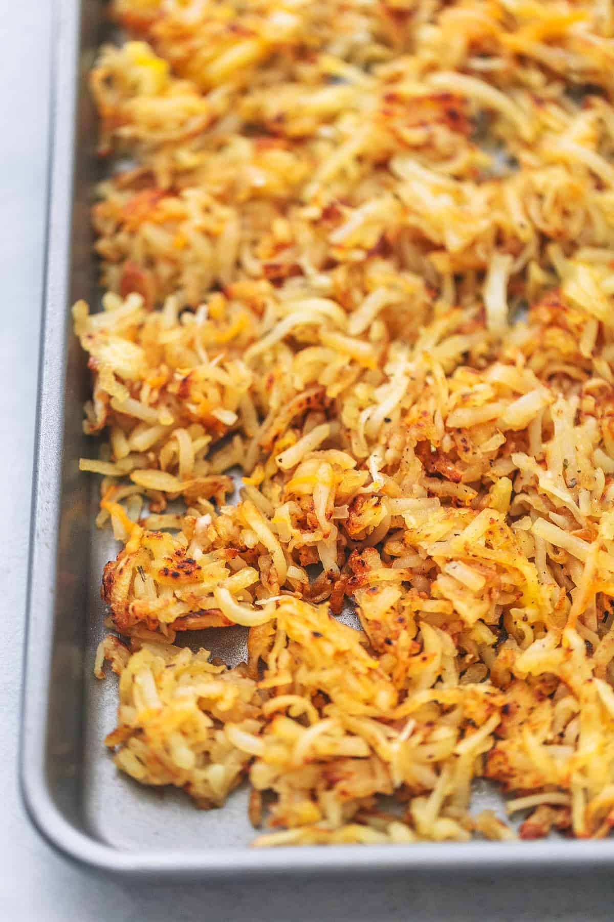 close up of hash browns on a sheet pan.
