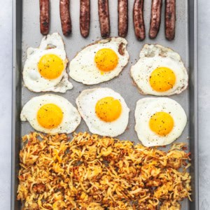 Easy, one pan SHEET PAN BREAKFAST with crispy hashbrowns, eggs, and sausage. | lecremedelacrumb.com