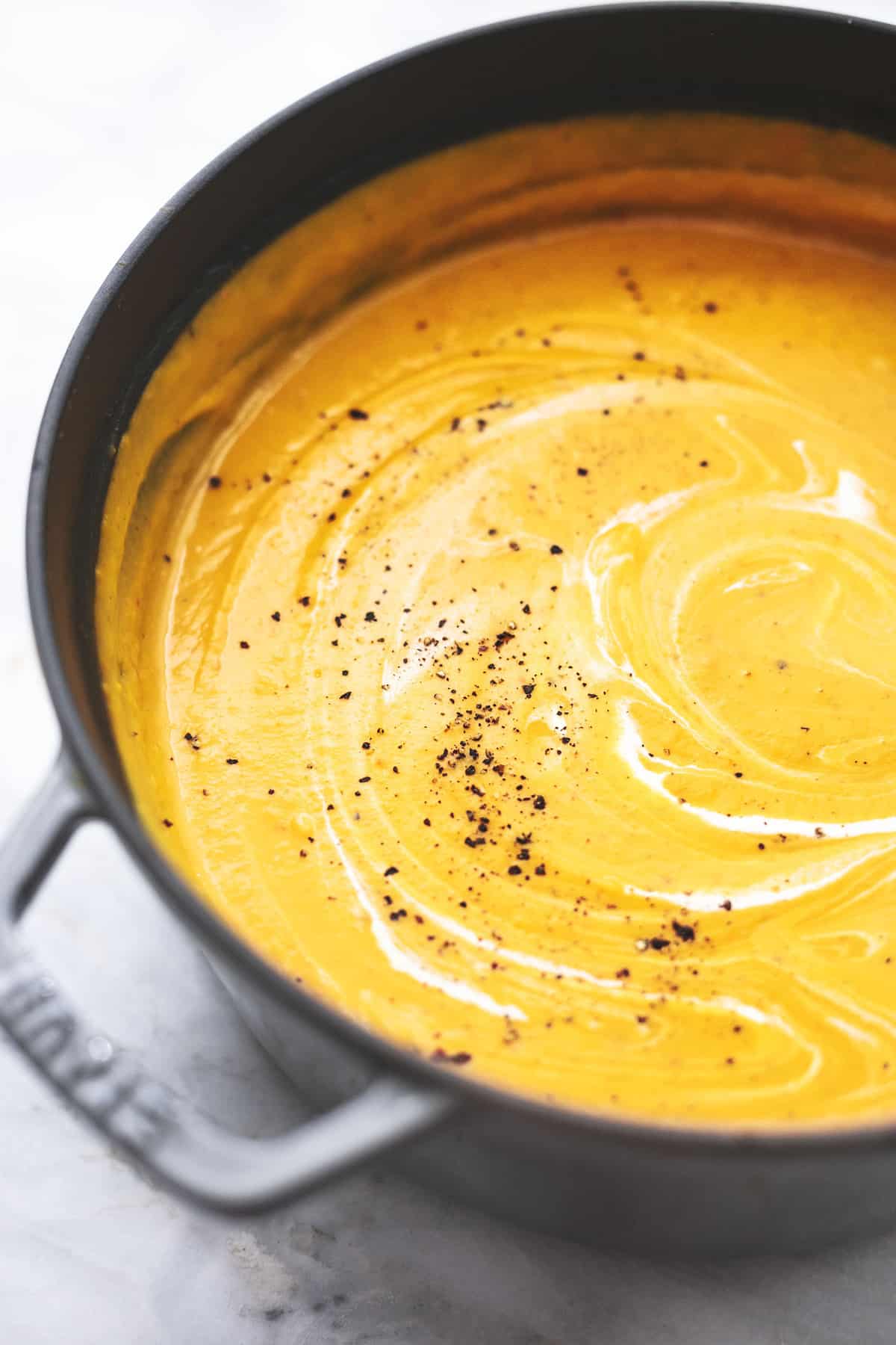 close up of creamy butternut squash soup in a pot.