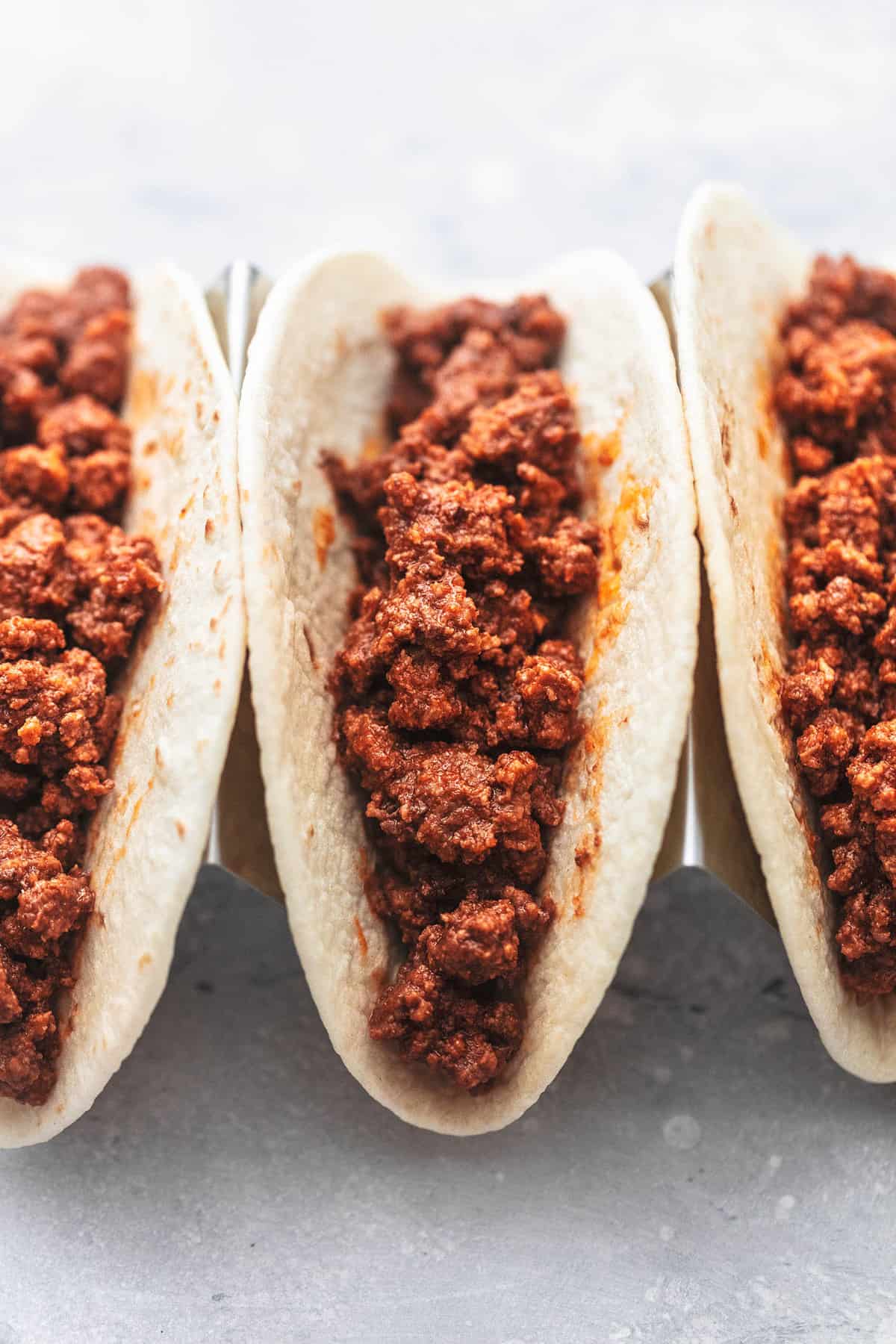 close up of ground beef tacos without toppings.