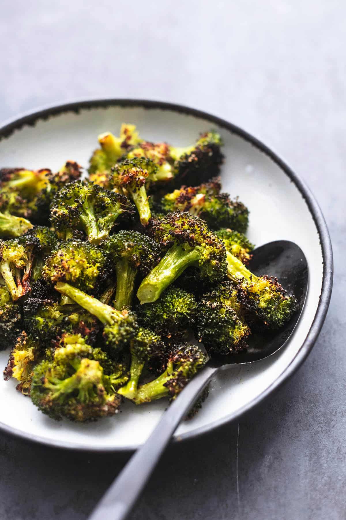 roasted broccoli with a spoon in a bowl.