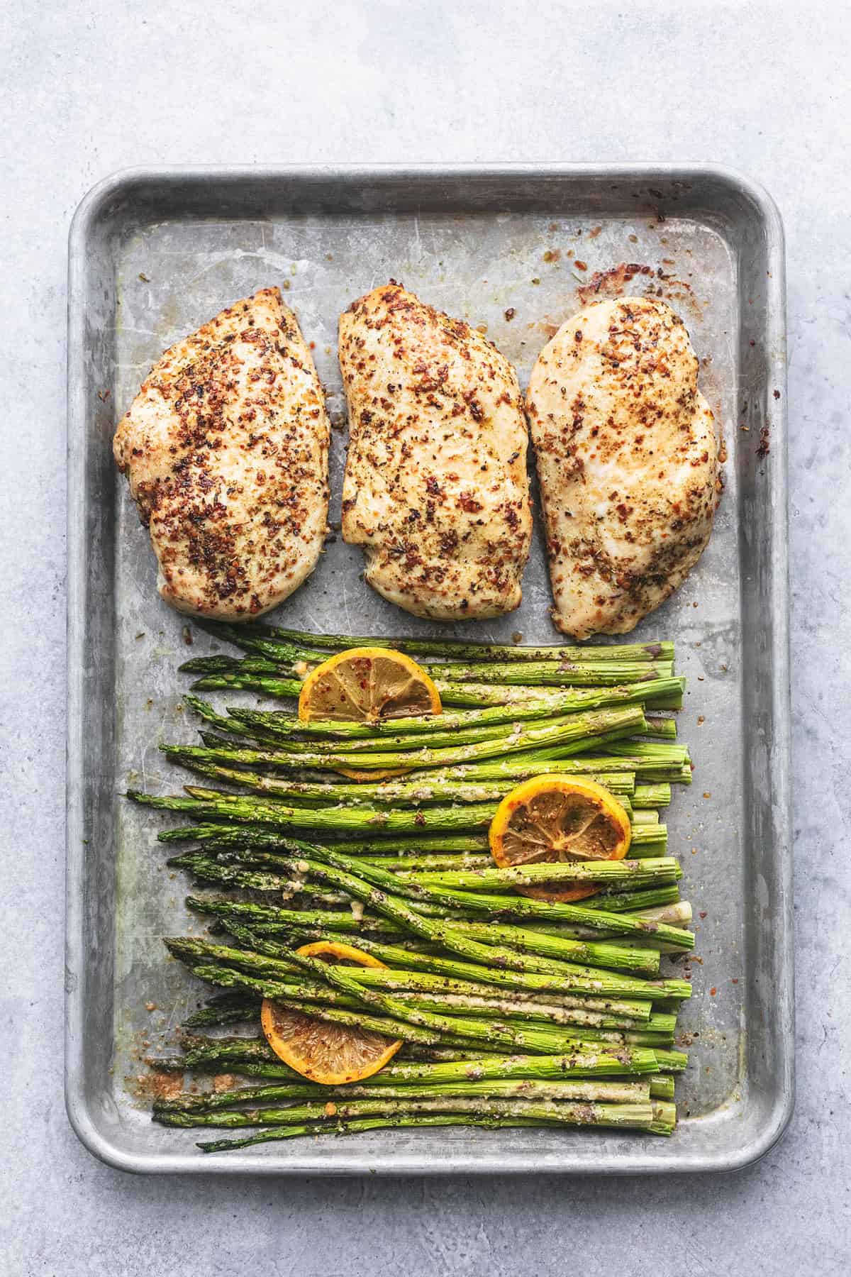 top view of sheet pan chicken and asparagus on a sheet pan.
