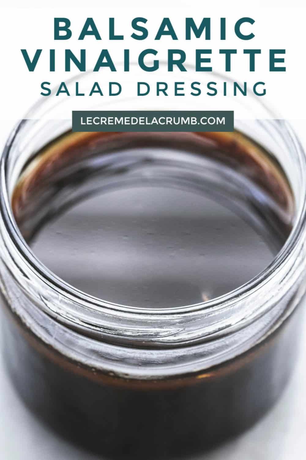 balsamic vinaigrette salad dressing in a jar with the title of the recipe written on the top of the image.