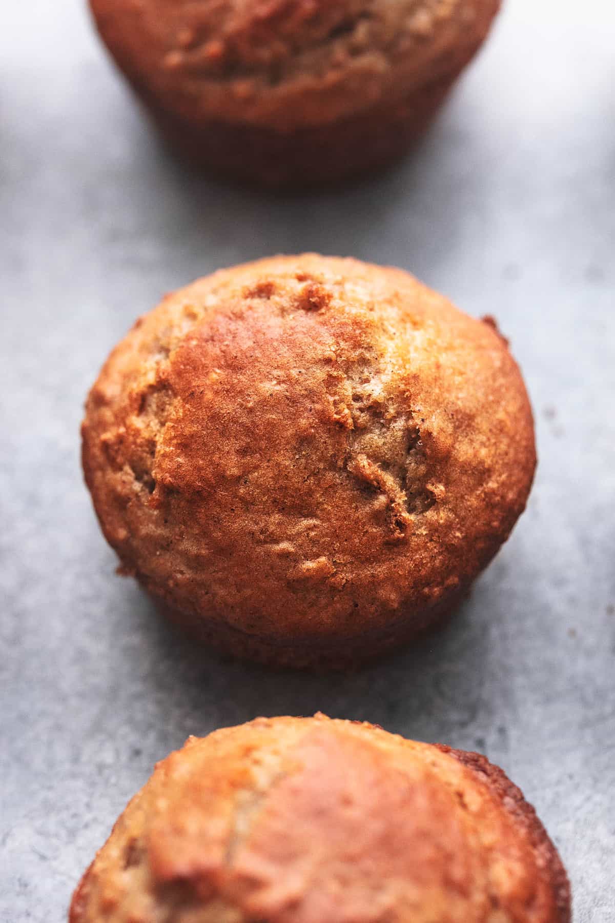 close up of a bran muffin with another muffin above and below it.