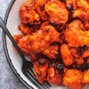 up close buffalo cauliflower on a plate with a fork