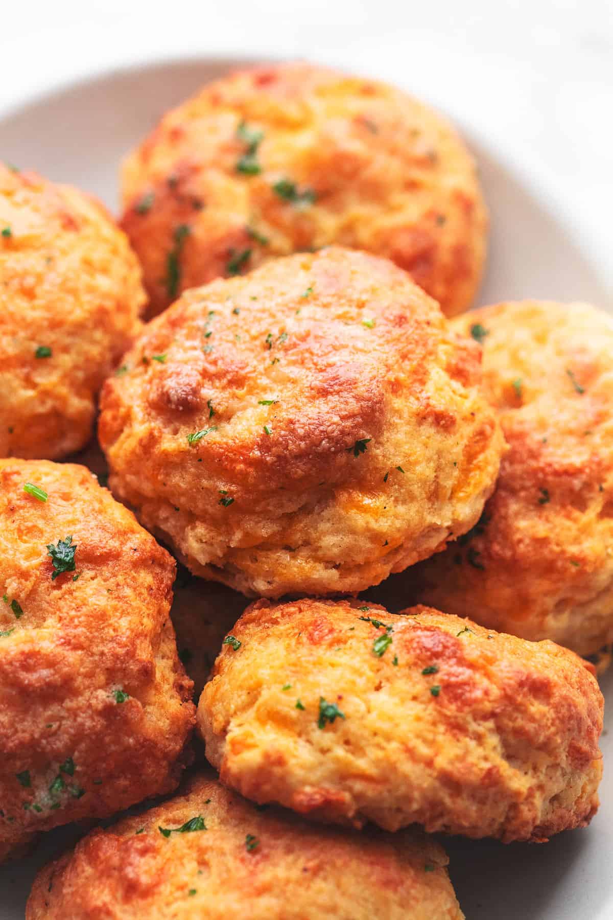 close up of red lobster cheddar bay biscuits on a plate.