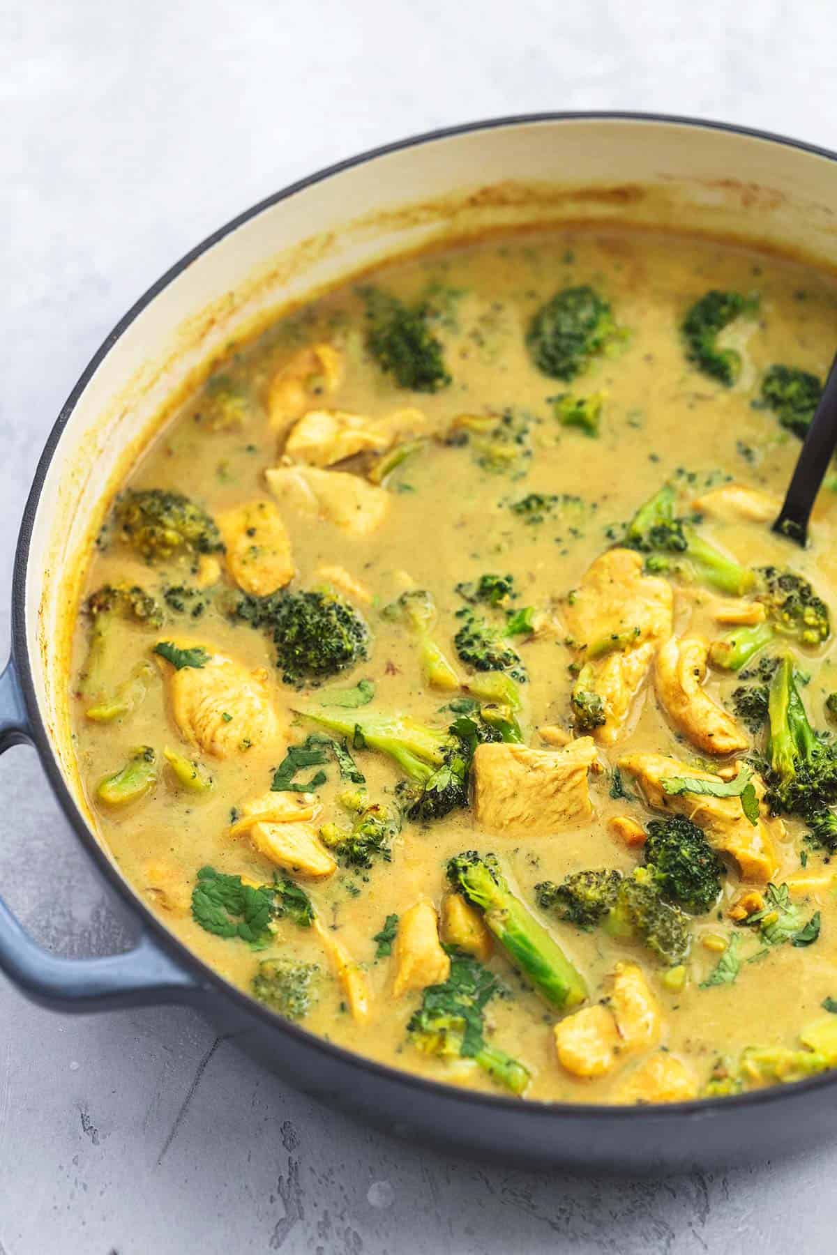 close up of chicken and broccoli coconut curry in a pot.