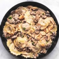 mushroom ravioli with creamy sauce in a skillet