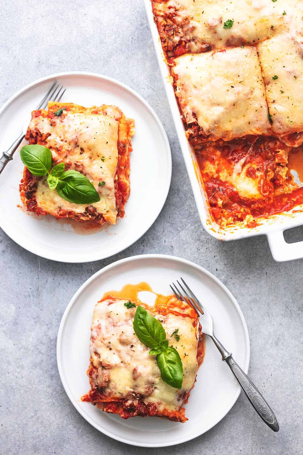 a pan of lasagna and two plates of lasagna