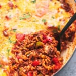 up close stuffed pepper casserole with a spoon in a skillet