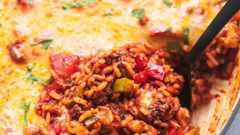 up close stuffed pepper casserole with a spoon in a skillet