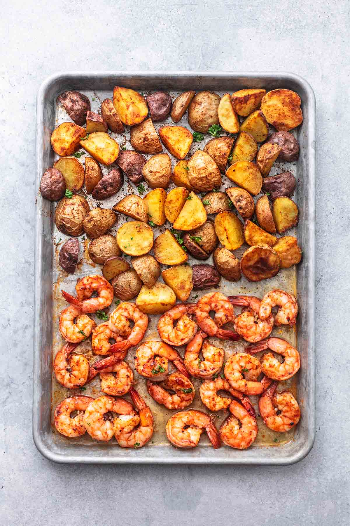 top view of sheet pan cajun shrimp and potatoes on a sheet pan.