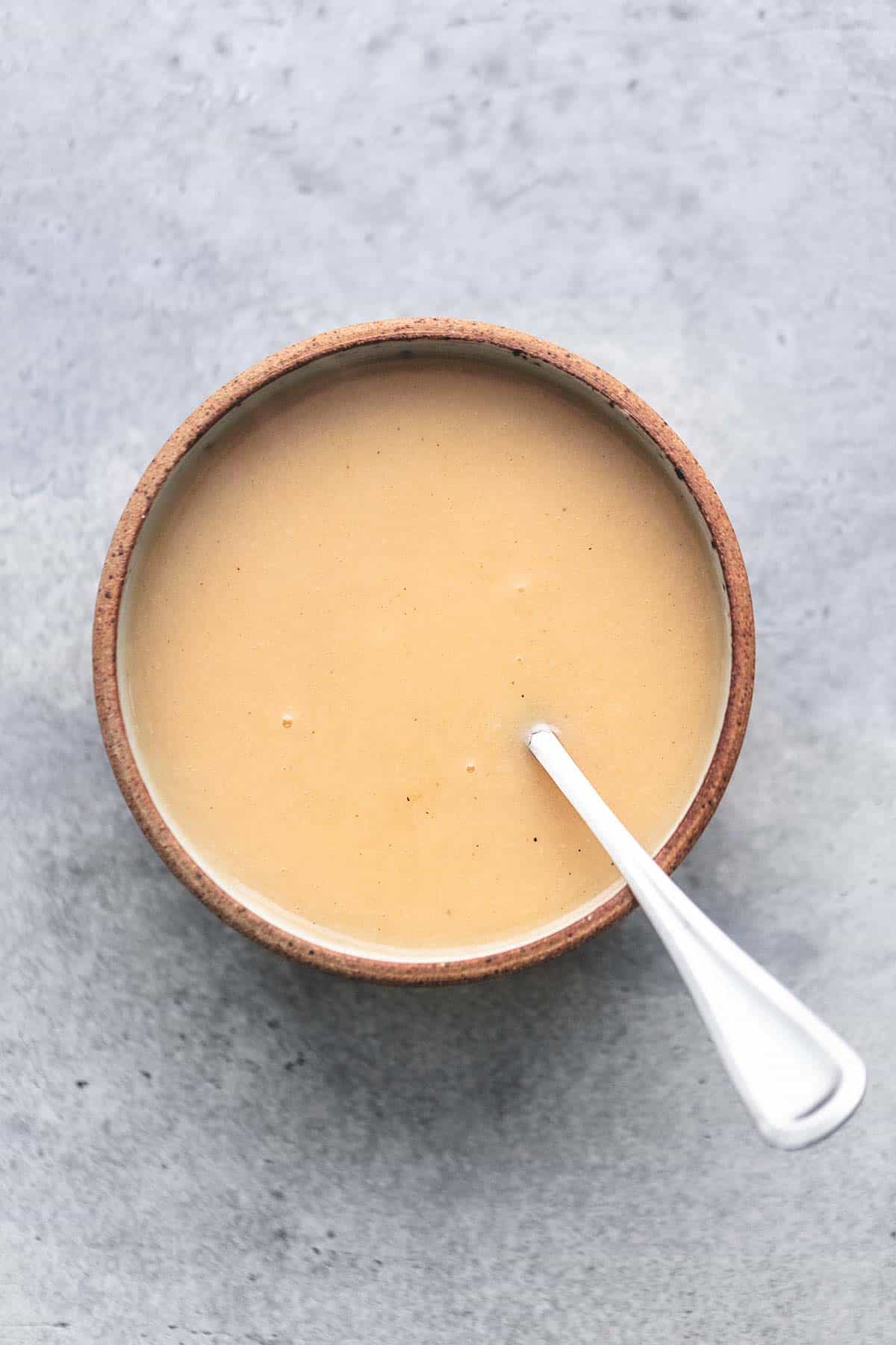 gravy with a spoon in a bowl overhead