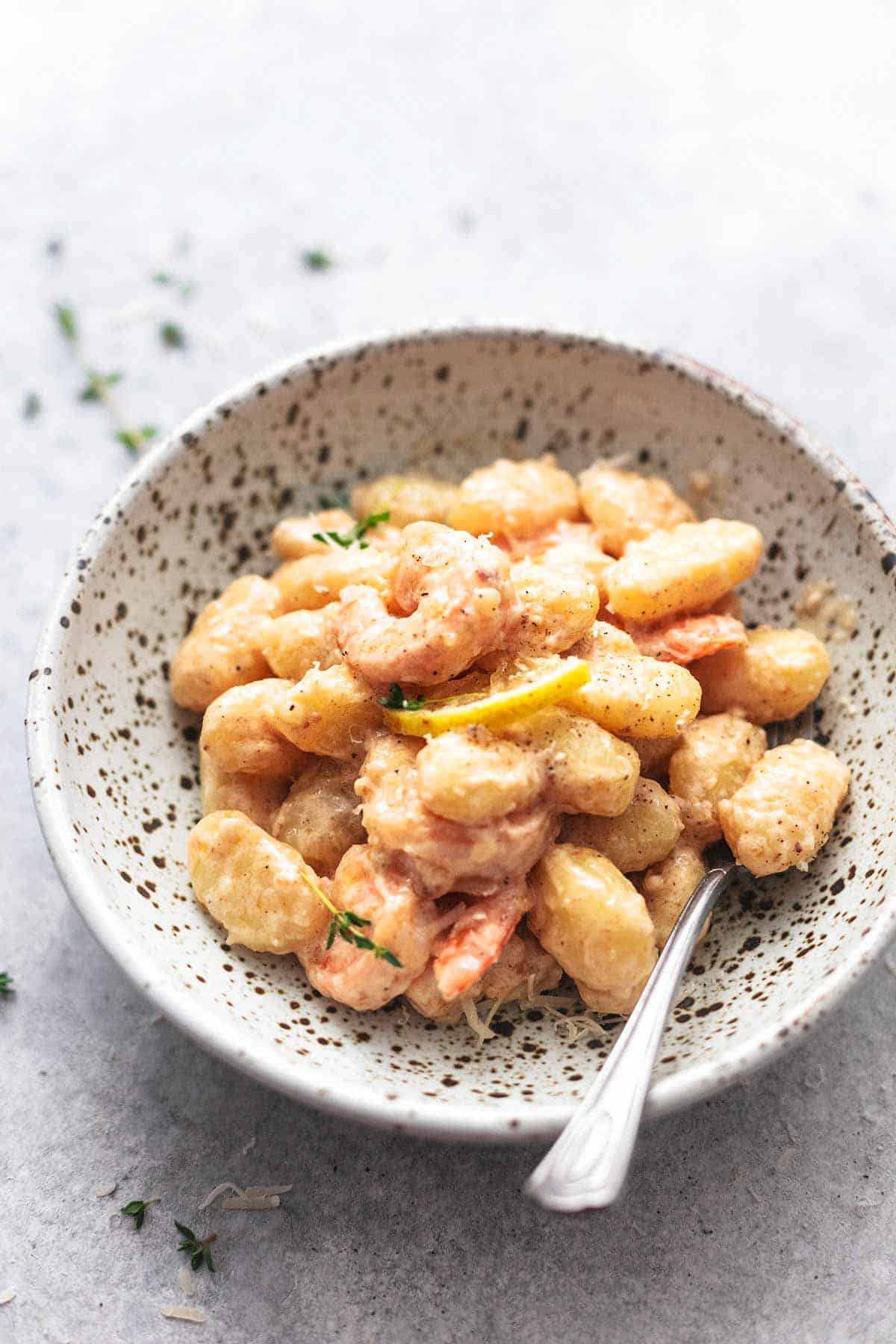 creamy lemon garlic shrimp and gnocchi in a bowl with a fork.