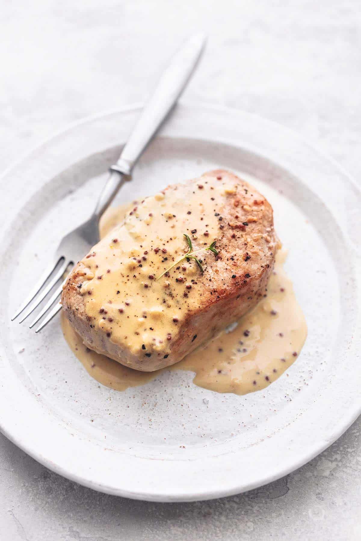 pork chops with cream sauce on a plate