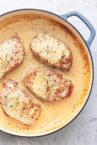 pork chops with creamy dijon sauce in a skillet
